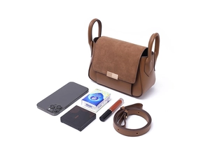 Internal capacity of brown patchwork crossbody bag showing phone, tissues, and lipstick