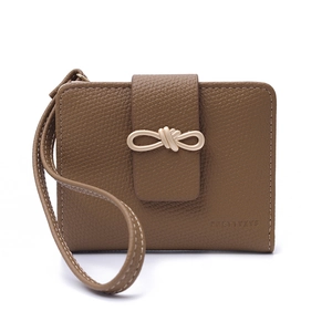 Detailed close-up of brown litchi pattern leather wallet with a golden knot clasp