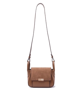 Detail of brown crossbody bag featuring mixed leather texture and rectangular metal clasp