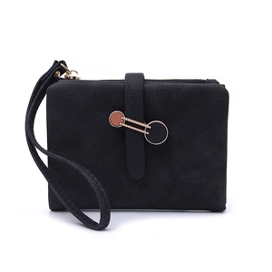 Detailed view of black matte wristlet wallet featuring gold metal buckle and zipper