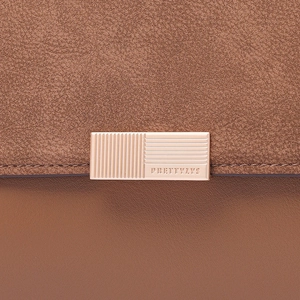 Detailed close-up of brown patchwork bag featuring a rose gold PRETTYZYS metal clasp lock