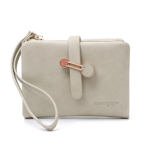 Detail of grey PU leather wallet featuring smooth zipper and metal ring buckle with wristlet