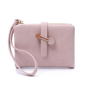 Detail of dusty pink PU leather wallet with golden round buckle and wristlet strap