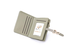 Detail view of light green PU leather wallet showing interior slots and zip pocket