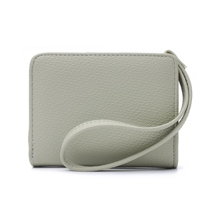 Detail view of sage green lychee pattern leather wallet with minimalist wrist strap