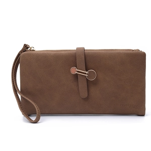 Detailed view of brown matte leather long wallet with metallic buckle and wrist strap
