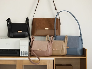 Close-up of stylish leather and suede patchwork crossbody bags in multiple colors and sizes