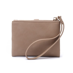 Detail view of the beige pebbled leather texture and metal zipper of the wallet