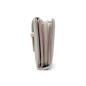 Side view of multi-layer sage green and dusty pink leather wallet with sturdy zipper