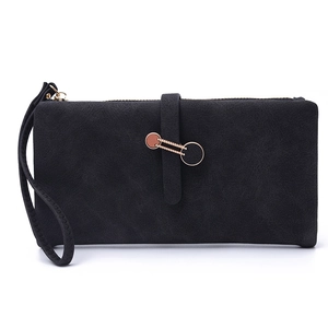 Detail view of black matte long wallet with wrist strap and gold paperclip buckle closure