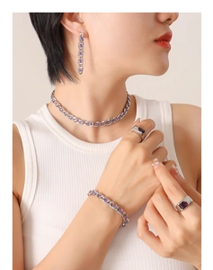 Close-up of luxury purple zircon jewelry set including necklace and earrings on model