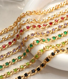 Macro shot of colorful square-cut gemstones on a gold-plated Cuban link chain
