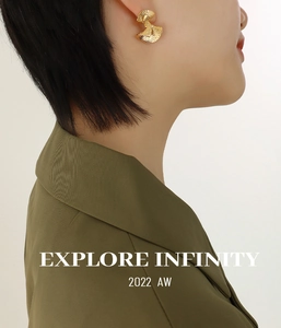 Detailed view of gold geometric fan earrings with hammered texture on a model