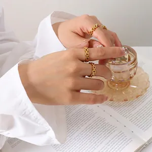 Three-piece gold plated chain link rings set for women displayed on model fingers