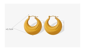 Detailed view of wide golden teardrop earrings with a diameter of about 3.1cm
