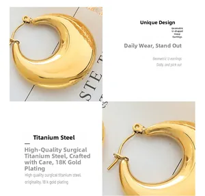 Macro detail of thick U-shaped geometric hoop earrings in 18K gold plated titanium steel