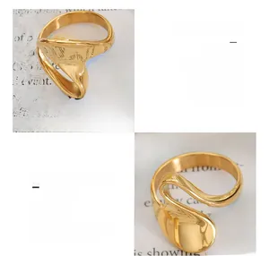Macro detail of wave shaped 18K gold plated titanium steel ring with glossy finish