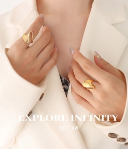 Close-up of golden irregular wavy rings with liquid metal texture and polished finish