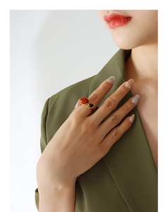 Close-up of vintage gold titanium ring featuring natural red stone and tiger eye stone