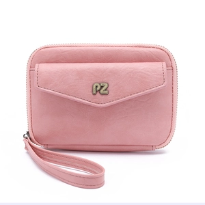 Detail of pink leather passport holder featuring an envelope pocket and wrist strap