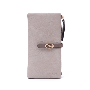 Macro detail of leaf-shaped gold buckle and wrinkled leather texture on long wallet