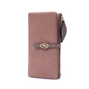 Detail of dusty pink PU leather wallet featuring leaf-shaped metal buckle and zip tassel