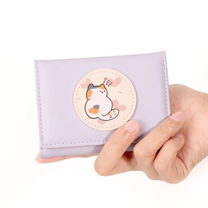 Detail of lavender cat wallet showing the cute tricolor kitten patch and stitching