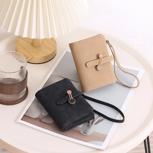 Detail of khaki PU leather wallet with metal ring buckle, wrist strap and embossed logo