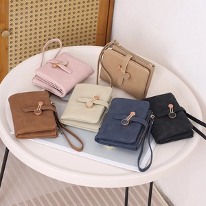 Short women wallets in multiple colors featuring matte leather finish and metal ring buckles