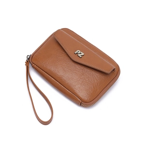 Detailed view of brown lychee grain leather wristlet bag with silver PZ logo