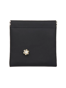 Close-up of black crocodile pattern storage bag with metal squeeze closure and floral stud