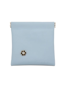 Close-up of light blue crocodile texture pouch with a golden flower rhinestone clasp