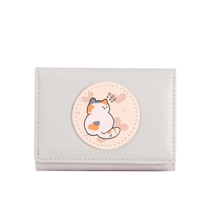 Close-up of a light grey tri-fold wallet with a cartoon cat and pink heart patch