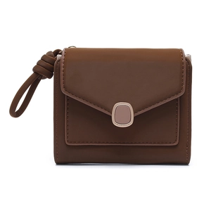 Detail of dark brown tri-fold envelope wallet featuring silver metal buckle and knotted handle