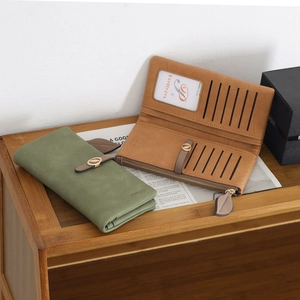 Detail of long leather wallet interior showing multiple card slots and metal buckle