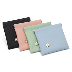 Close-up of crocodile pattern PU leather pouches with gold flower clasps in four colors