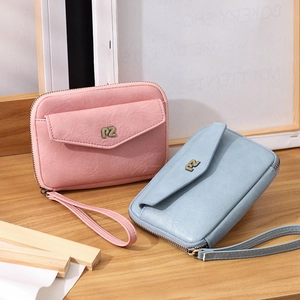 Detailed close-up of pink and blue PU leather passport wallets with PZ metal logos