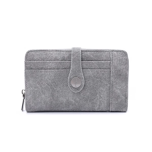 Close-up of grey fabric wallet featuring card slots and silver button fastener
