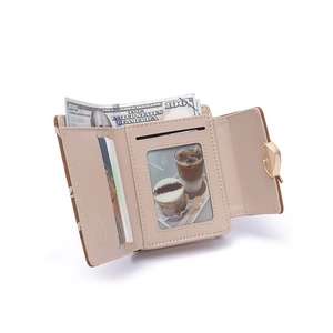 Detail of compact tri-fold wallet showing card slots, ID window, and heart buckle