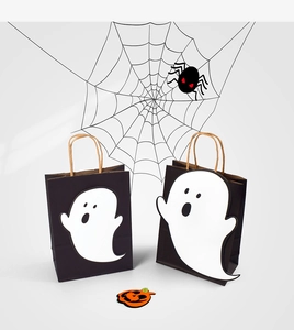 Detailed view of Halloween ghost paper gift bags with black bodies and white ghost cutouts