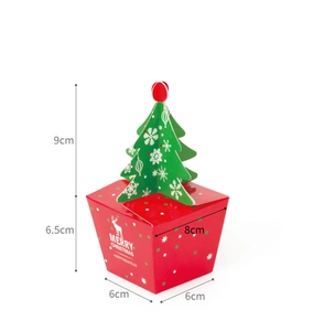 Detail of red Christmas gift box featuring white reindeer and a 3D green paper tree on top