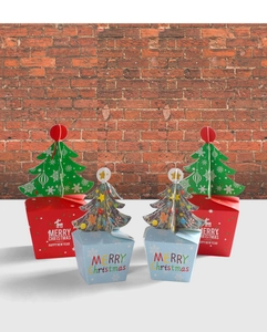 Detail of Christmas gift boxes with 3D tree toppers and festive reindeer graphics