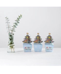 Three light blue Christmas gift boxes with 3D tree toppers and gingerbread man patterns