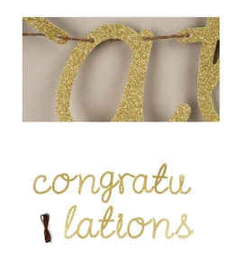 Macro detail of gold glitter Congratulations banner showing texture and hanging string