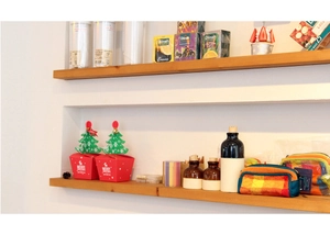 Red Christmas gift boxes with snowflake patterns on minimalist wooden floating wall shelves
