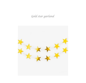Close-up of shiny gold mirror star garland hanging on white string for party decoration