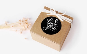 Brown kraft gift box with black I love you sticker and white ribbon bow detail