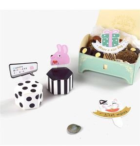 Macro detail of hexagonal gift boxes with polka dots and cute cartoon decorative cards