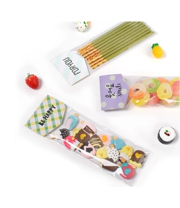 Detailed view of mini food charms in transparent bags with colorful paper headers