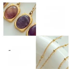 Close-up of 18K gold-plated titanium steel necklace with natural amethyst pendant